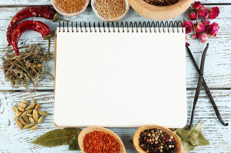 spices-with-recipe-book-color-wooden-table-background_392895-361235